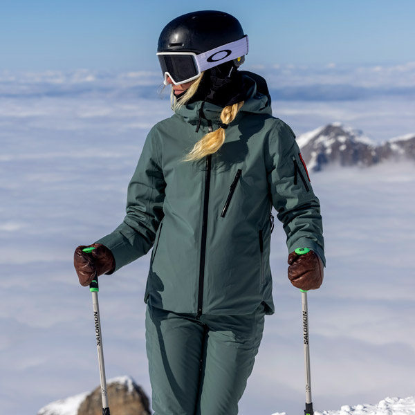Woman standing on skis in Vail in The Mountain Studio ski wear