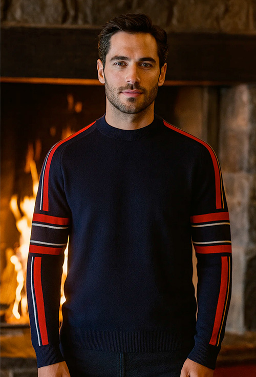 Man wearing a Fusalp ski sweater in front of a fire place