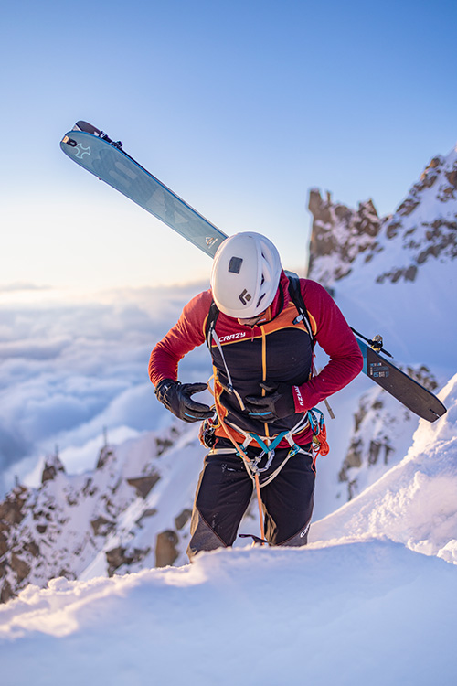 Man wearing Crazy French ski wear in the mountains