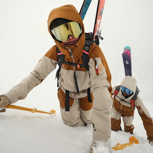 Man and women wearing Elevenate ski jackets