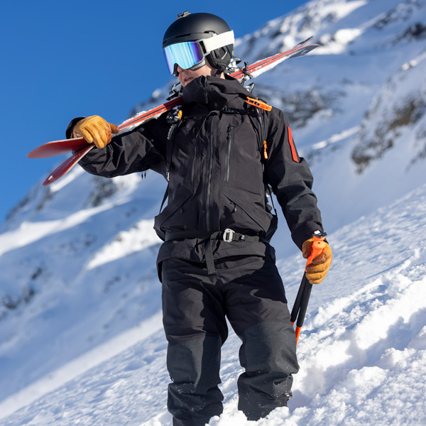 Man on ski slope wearing a ski jacket and ski pants from The Mountain Studio